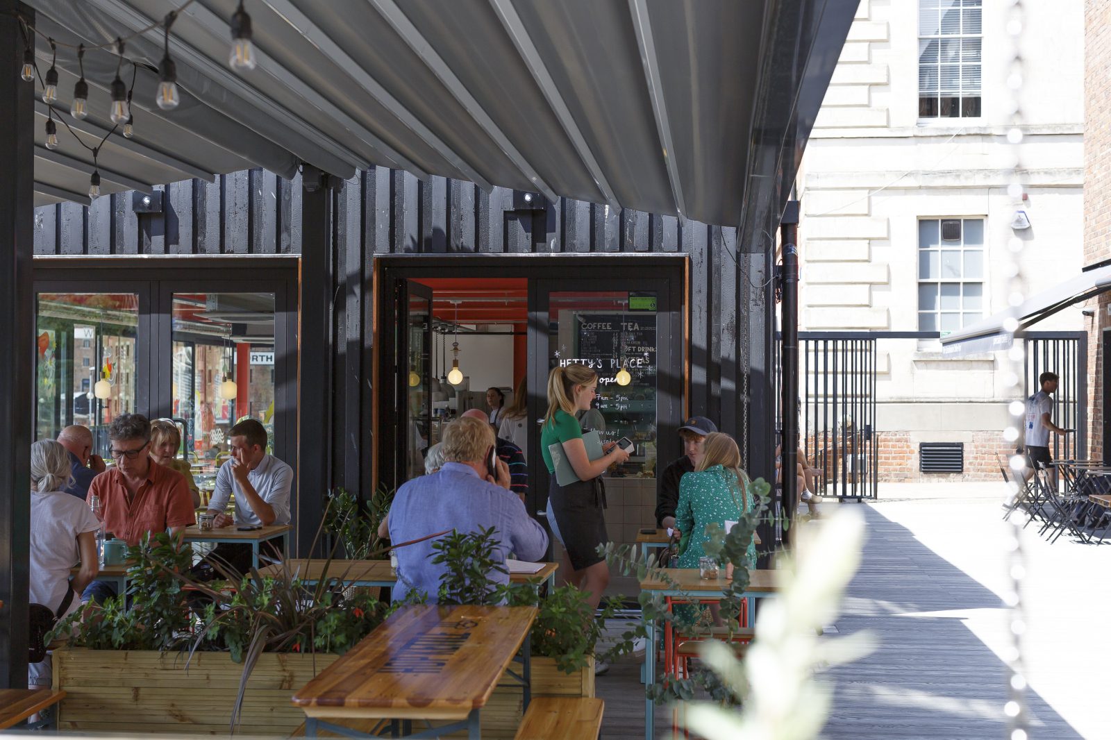 Under the canopy on the deck level, customers sit, enjoying their brunch from Hetty's Place.