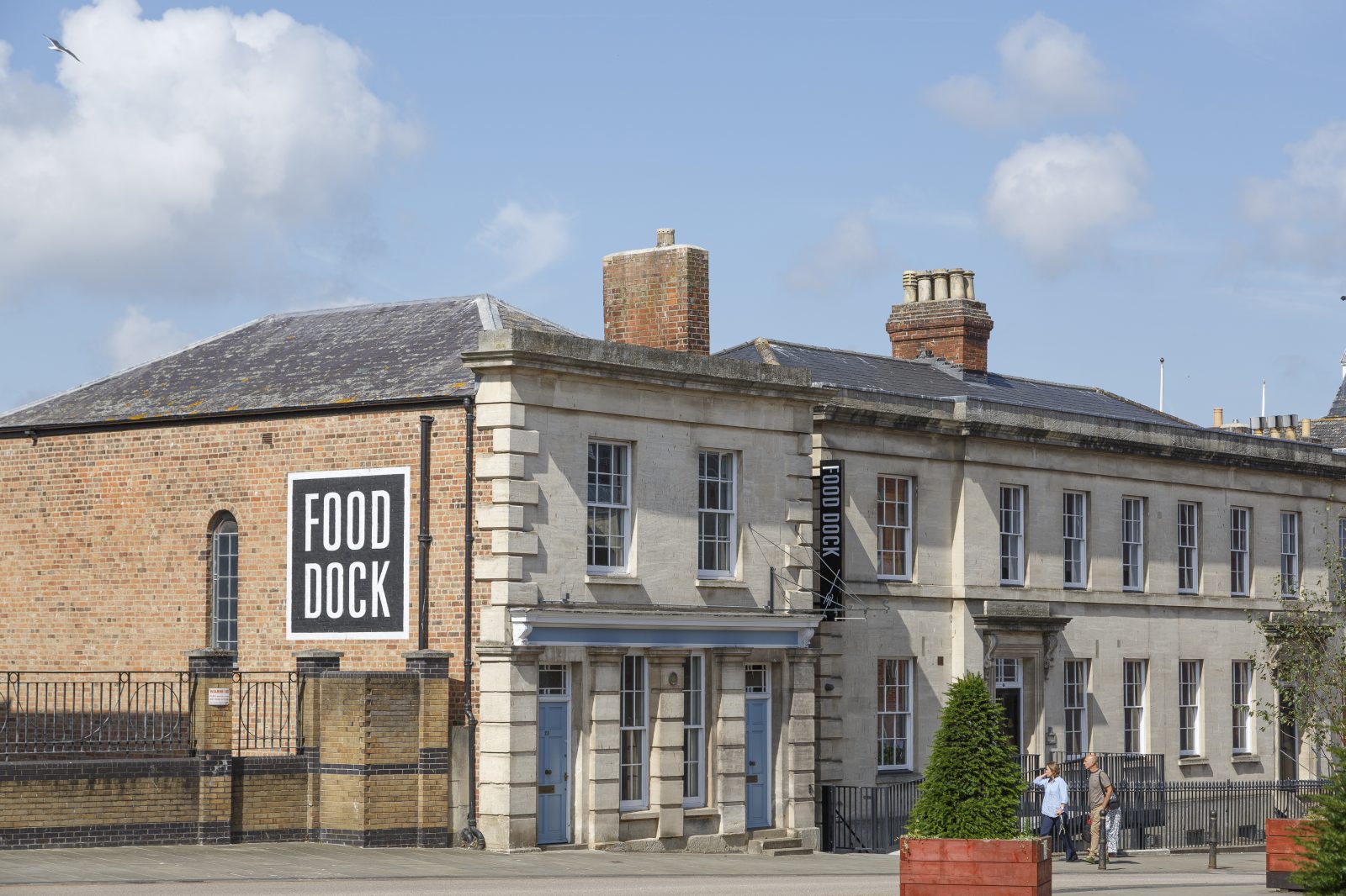 The historic navigation house with a white on black "Food Dock" painted sign.