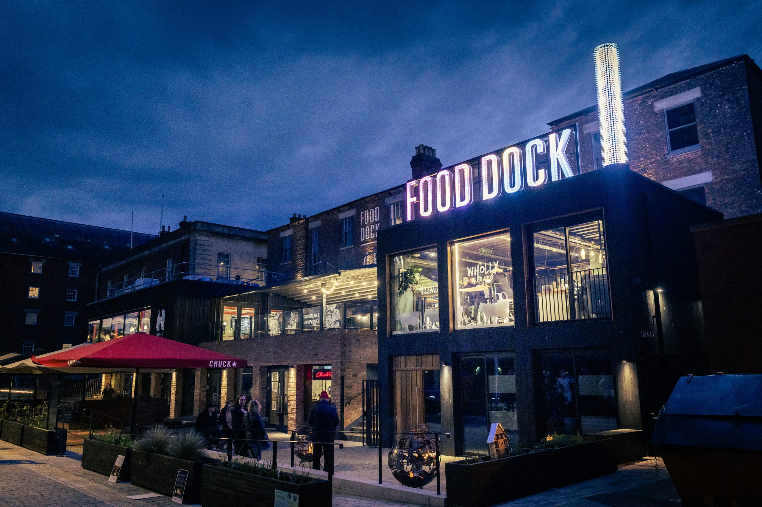 The night lit up but Gloucester Food Dock's light art installation and hanging lights.